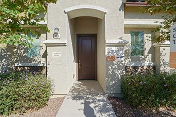 The entrance to a building with a brown door